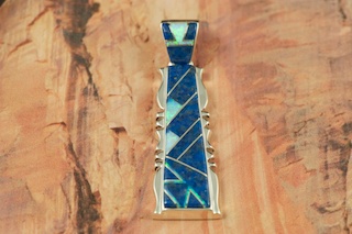 Genuine Blue Lapis inlaid between ribbons of Sterling Silver. Stunning Pendant features Fire and Ice Lab Opal Accents.  Free 18